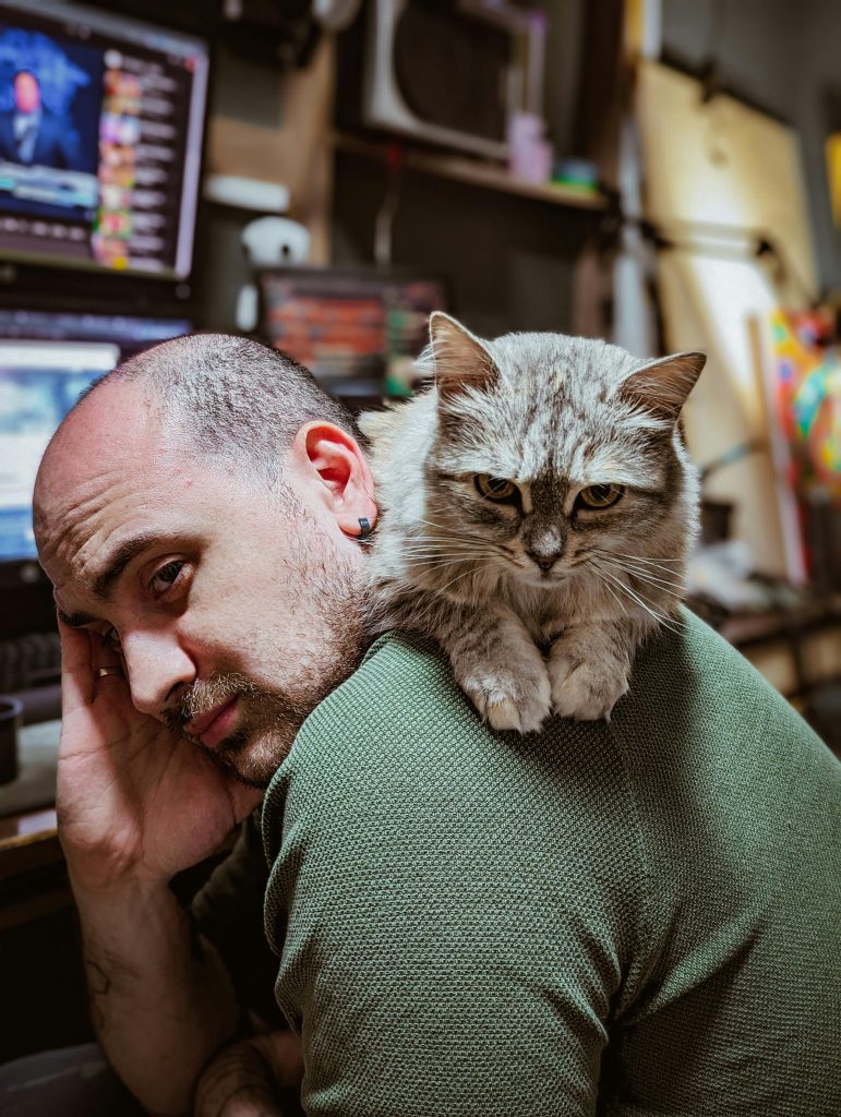 Cat Lying on a Man’s Back